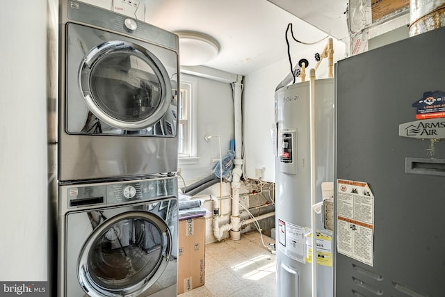 clothes washing area with stacked washer and clothes dryer and water heater