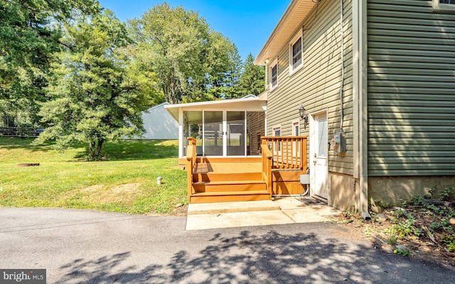 exterior space featuring a lawn and a wooden deck