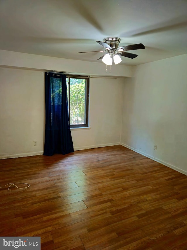 unfurnished room with ceiling fan and hardwood / wood-style flooring