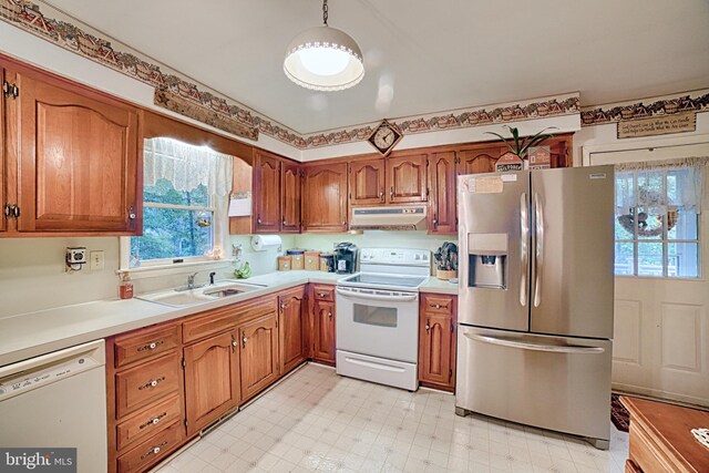 kitchen featuring white appliances and sink