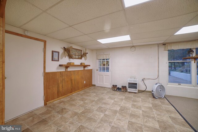 basement with heating unit and a paneled ceiling