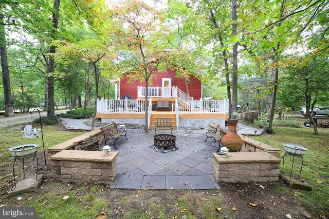 view of patio with a deck and an outdoor fire pit