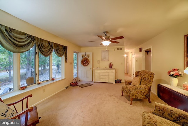 sitting room featuring ceiling fan and carpet flooring