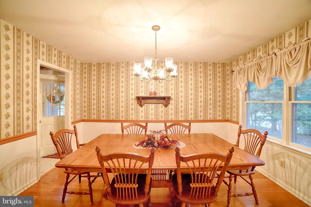 dining area featuring an inviting chandelier and hardwood / wood-style floors