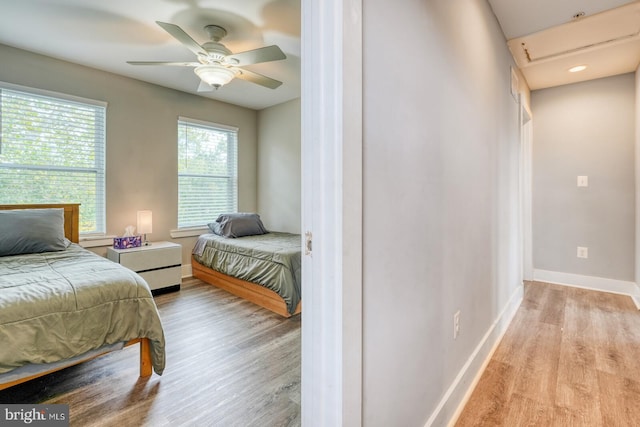 bedroom with light wood-type flooring and ceiling fan