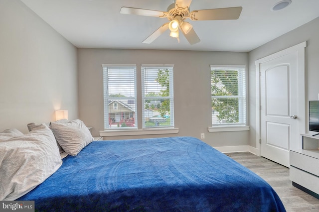 bedroom featuring light hardwood / wood-style floors and ceiling fan