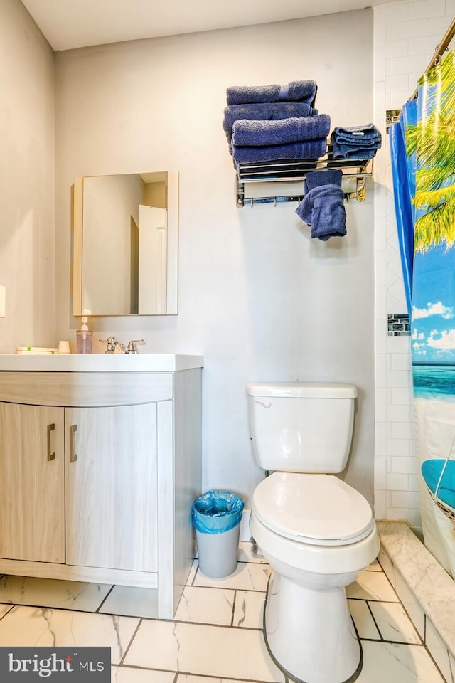 bathroom featuring vanity, toilet, and curtained shower