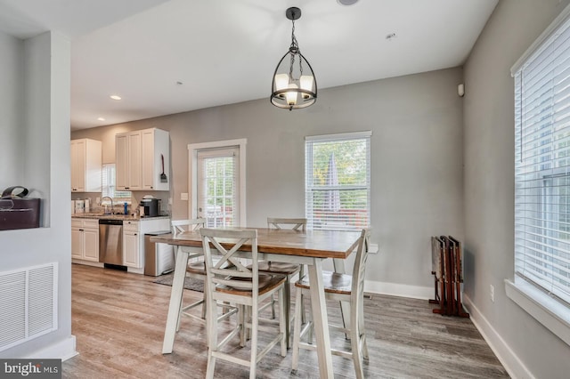 dining area featuring light hardwood / wood-style floors and radiator heating unit