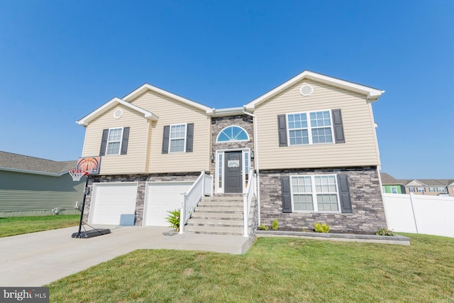 bi-level home with a garage and a front yard