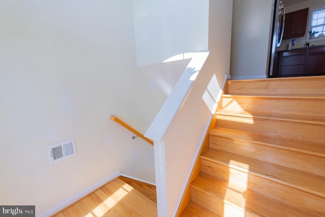 stairway featuring hardwood / wood-style floors