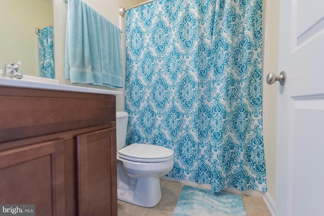 bathroom with vanity, toilet, tile patterned floors, and curtained shower