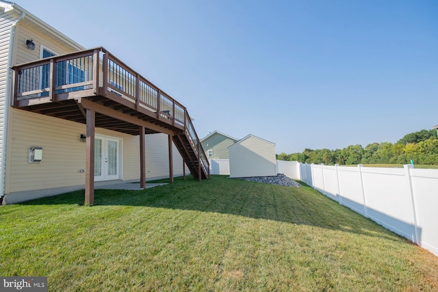 view of yard featuring a deck and french doors