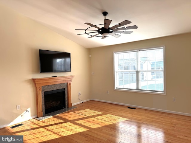 unfurnished living room with light hardwood / wood-style floors, lofted ceiling, and ceiling fan