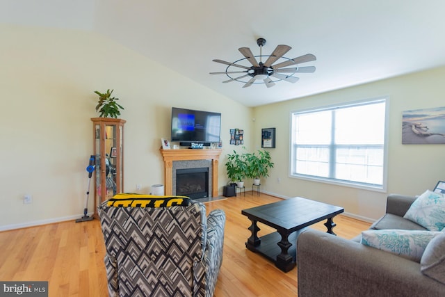 living room featuring light wood-type flooring, vaulted ceiling, and ceiling fan