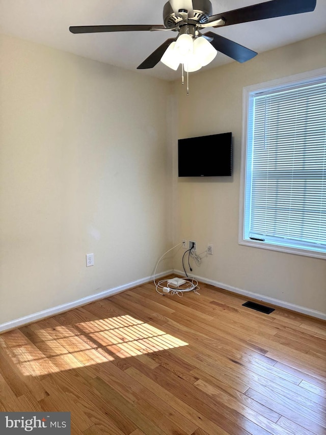 unfurnished room with light wood-type flooring and ceiling fan