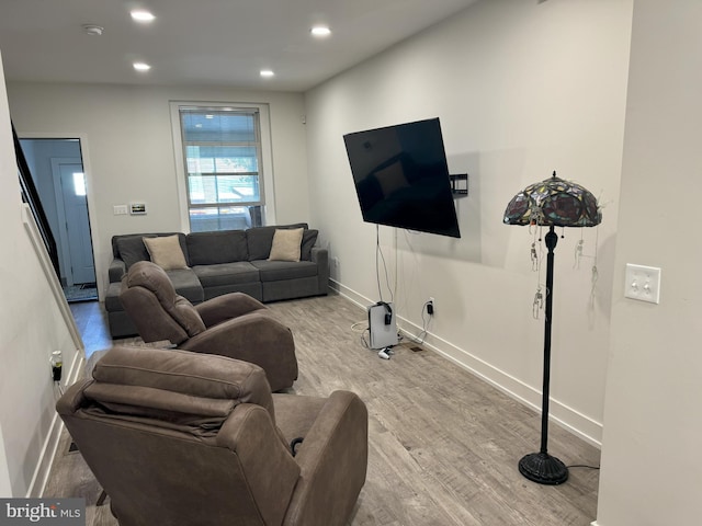 living area with recessed lighting, wood finished floors, and baseboards