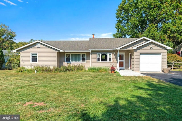 ranch-style home with a garage and a front yard