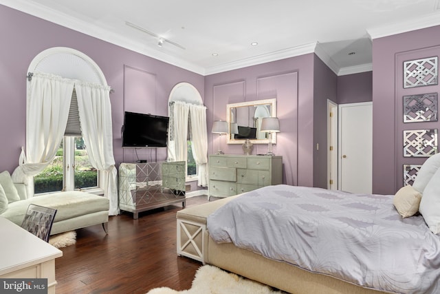 bedroom featuring hardwood / wood-style flooring, crown molding, and track lighting