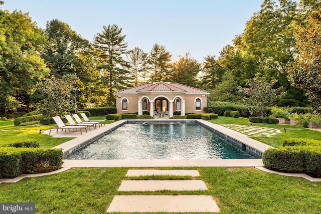 view of swimming pool featuring a lawn and a patio area