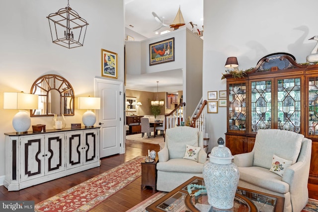 living room featuring an inviting chandelier, dark hardwood / wood-style flooring, and high vaulted ceiling