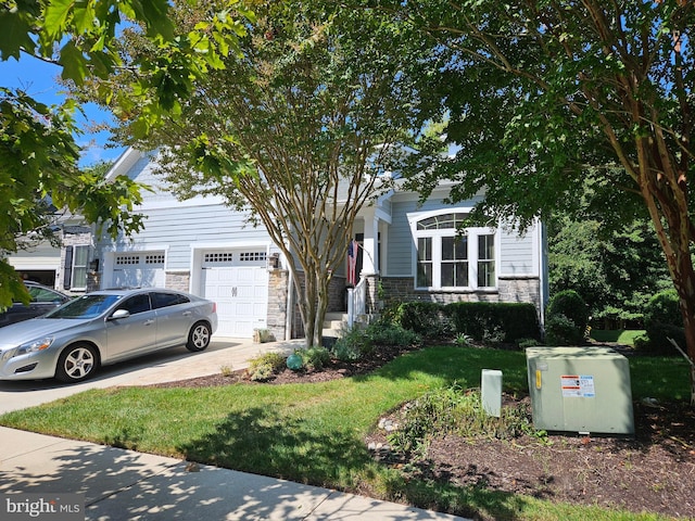 obstructed view of property featuring a garage and a front lawn