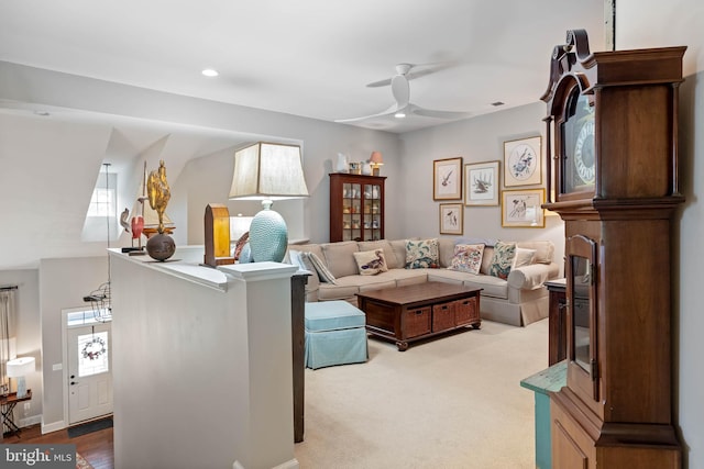 living room with a fireplace, vaulted ceiling, light carpet, and ceiling fan