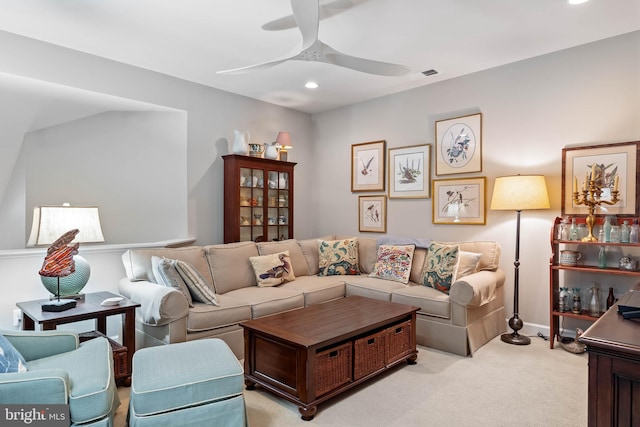 carpeted living room featuring ceiling fan