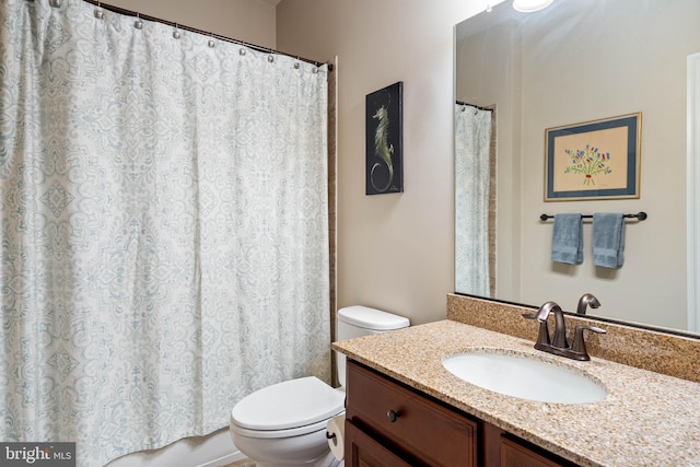 bathroom featuring vanity, toilet, and a shower with curtain