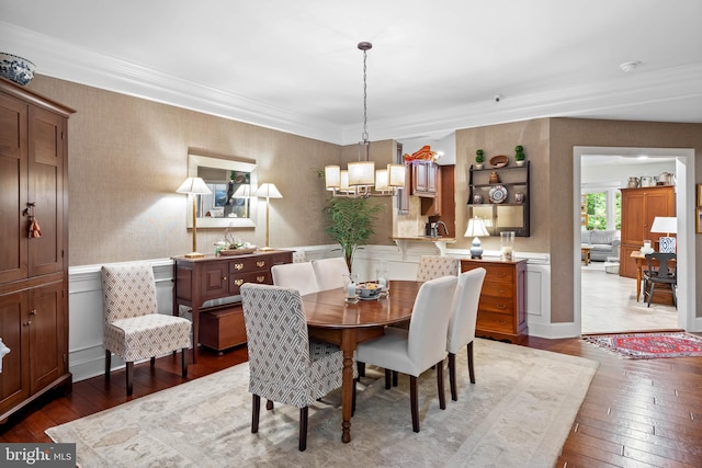 dining area featuring an inviting chandelier and hardwood / wood-style floors