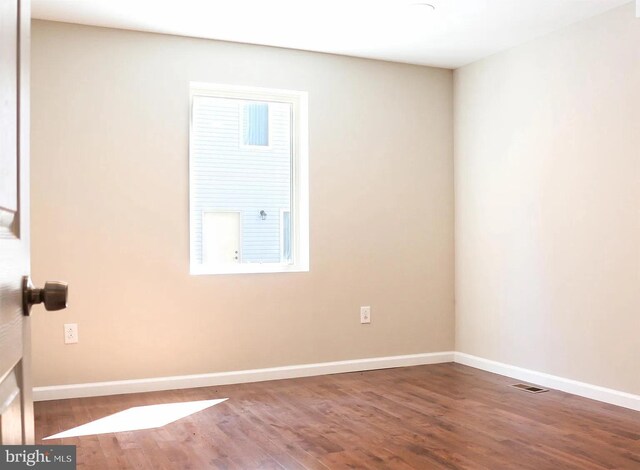 spare room with wood-type flooring