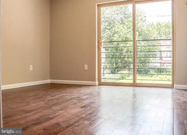 unfurnished room with hardwood / wood-style floors