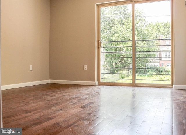empty room featuring baseboards and wood finished floors