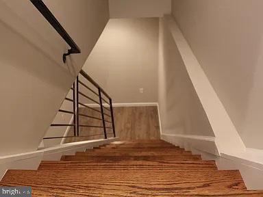 staircase with wood finished floors