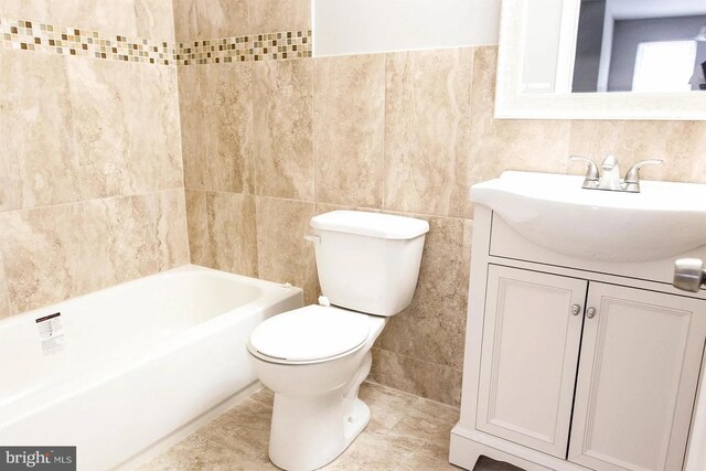 full bathroom featuring vanity, toilet, separate shower and tub, and tile walls