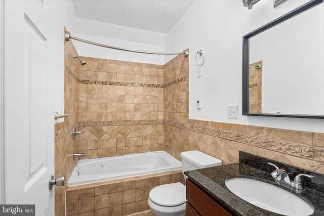 full bathroom with vanity, toilet, and tiled shower / bath