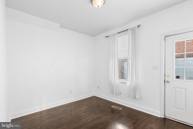 spare room featuring dark hardwood / wood-style floors