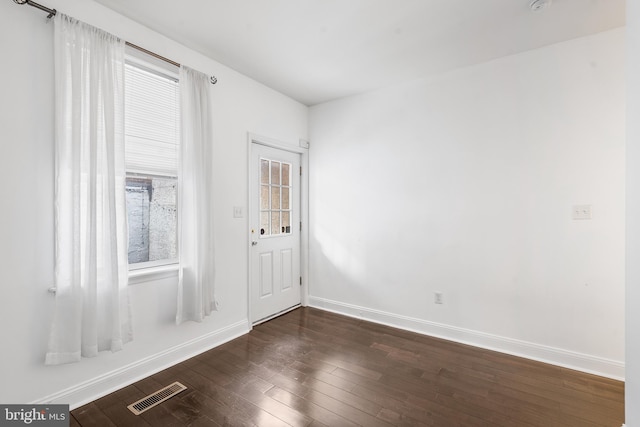 spare room with dark hardwood / wood-style floors