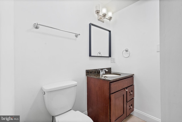 bathroom featuring toilet and vanity