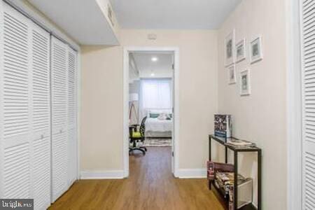 hallway with light hardwood / wood-style flooring