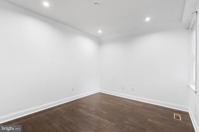 unfurnished room featuring dark wood-type flooring