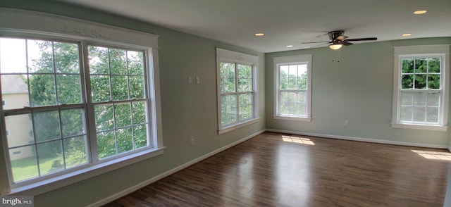 unfurnished room featuring dark wood-type flooring and ceiling fan