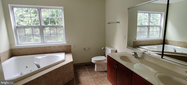 bathroom featuring plenty of natural light, toilet, and tiled tub