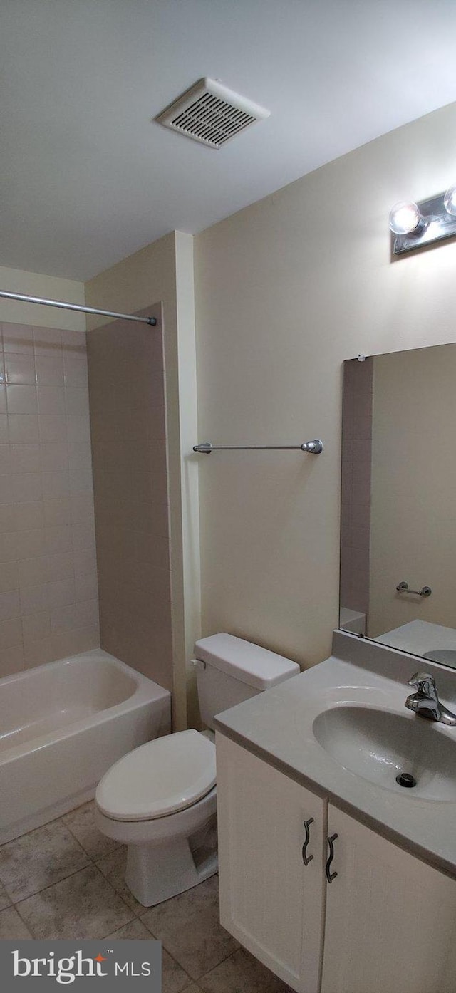 full bathroom featuring tile patterned flooring, vanity, toilet, and tiled shower / bath