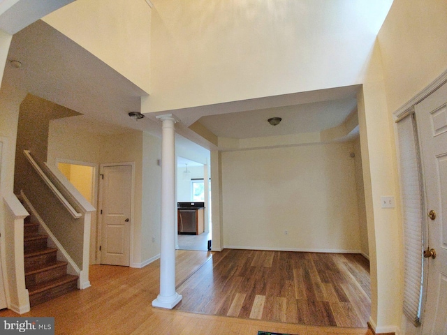 entrance foyer with hardwood / wood-style floors and ornate columns