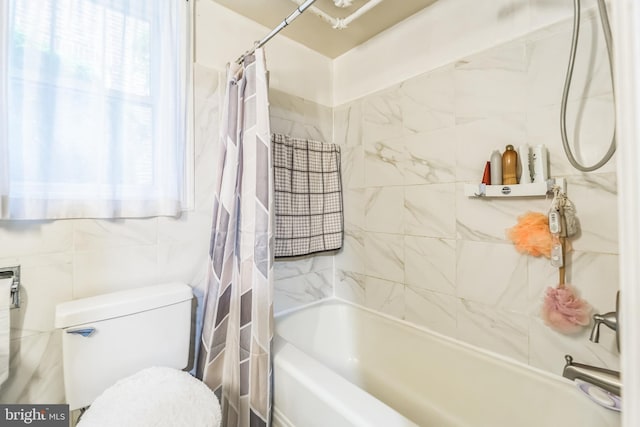 bathroom featuring toilet, shower / bathtub combination with curtain, and tile walls