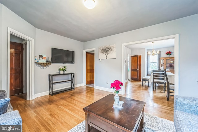 living room featuring hardwood / wood-style flooring and a notable chandelier