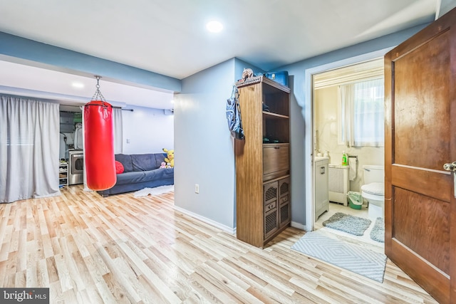 hallway with light hardwood / wood-style floors