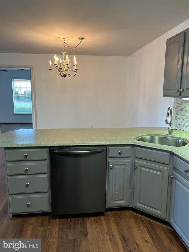 kitchen featuring gray cabinetry, sink, dishwasher, dark hardwood / wood-style flooring, and an inviting chandelier