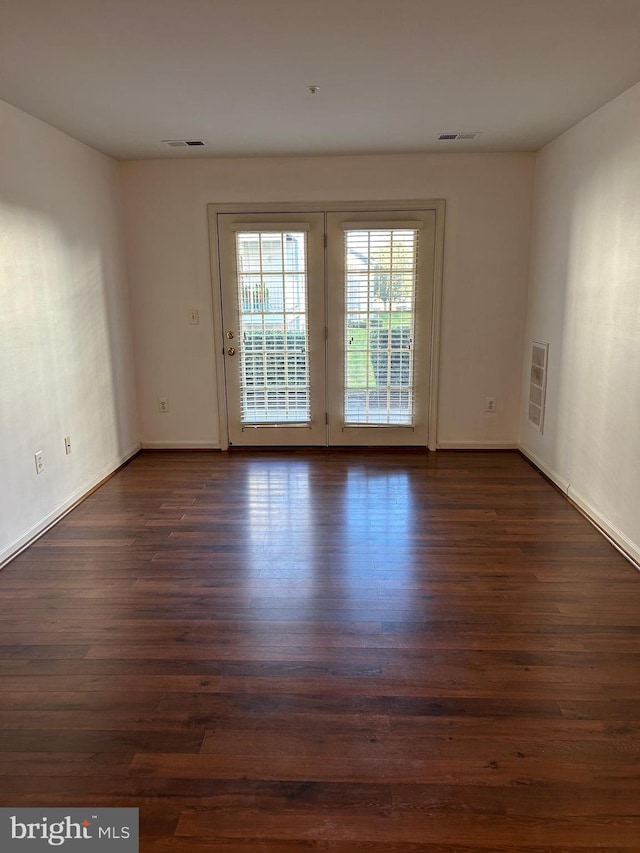 empty room with dark hardwood / wood-style floors