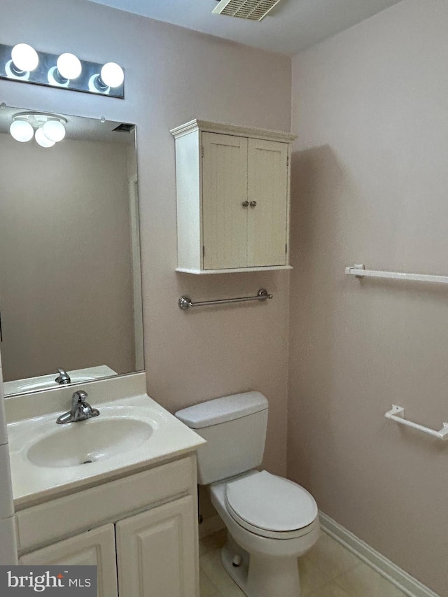 bathroom with vanity, toilet, and tile patterned flooring